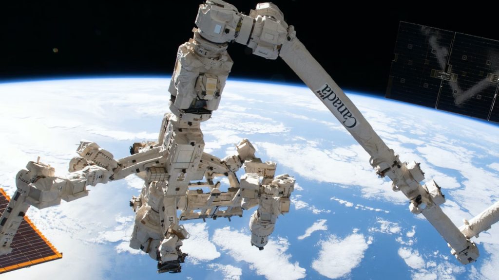 Canadaarm2 in space overlooking earth