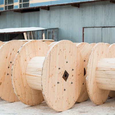 Large empty wooden coils. The new cable drums at the industrial area. Outdoors